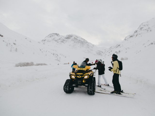 Skiers and ATV